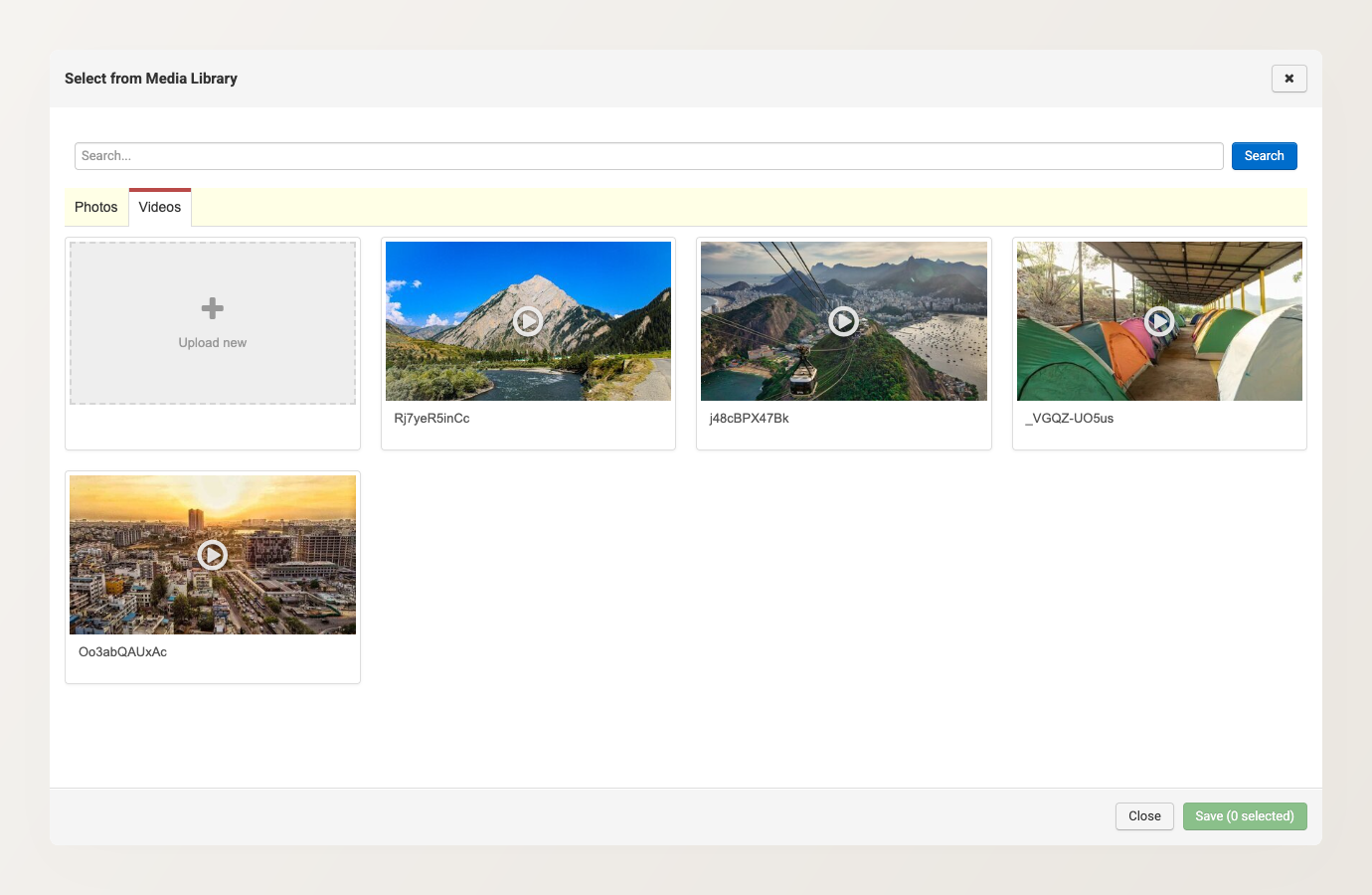 The media picker on the Videos tab, showing existing videos and the Upload new tile