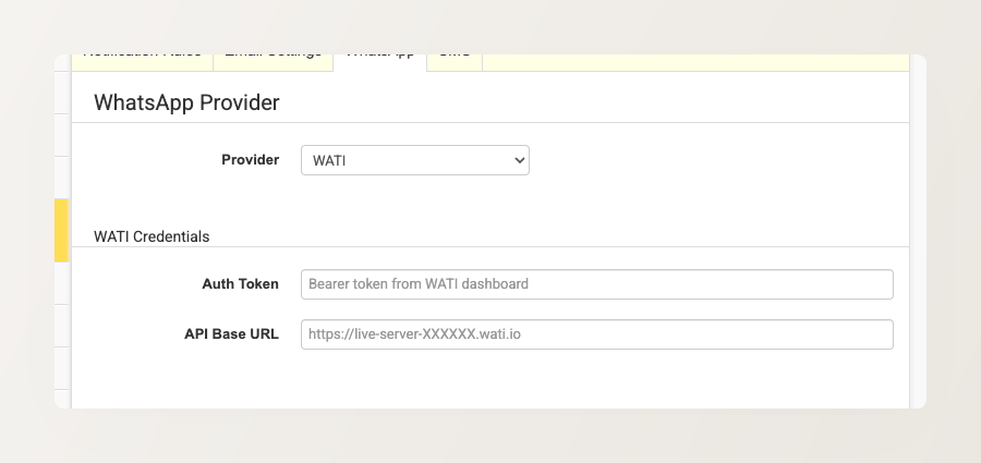 Backoffice screenshot of the WhatsApp tab under Emails, WhatsApp & SMS, showing the Provider selector and WATI credential fields